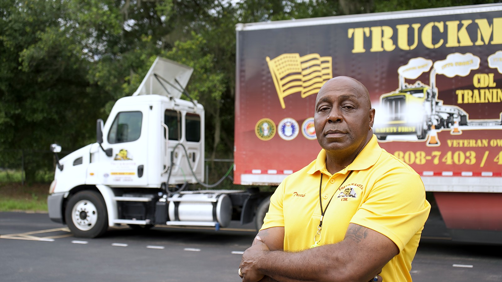Byron Simpson, U.S. Army Veteran owner of TruckMaster CDL, with the TruckMaster training fleet in Apopka, FL